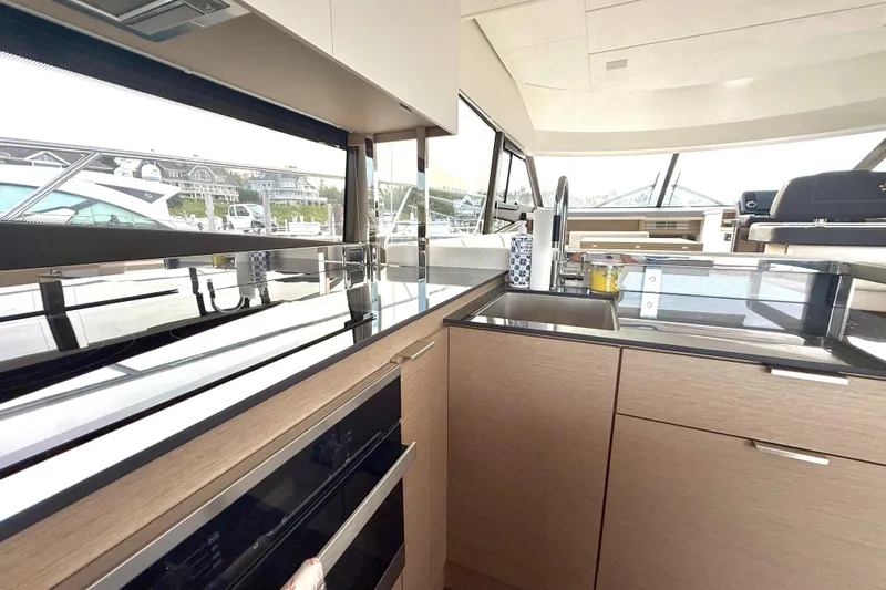 Freiheit Yacht Photos Pics Modern kitchen interior of 2020 Prestige 590 yacht with sleek countertops and ample natural light.