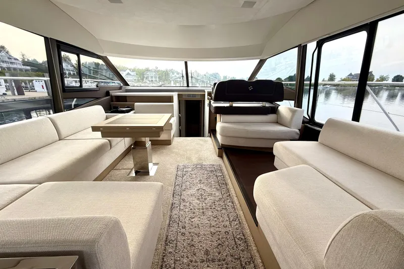Freiheit Yacht Photos Pics Luxurious interior of 2020 Prestige 590 yacht with elegant seating and panoramic windows.