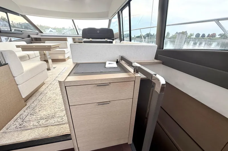 Freiheit Yacht Photos Pics Luxurious interior of 2020 Prestige 590 yacht with modern seating and dining area.