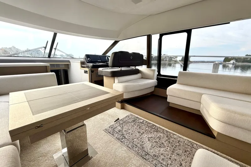 Freiheit Yacht Photos Pics Luxurious interior of 2020 Prestige 590 yacht with elegant seating and panoramic windows.