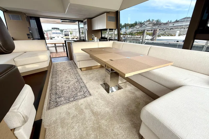 Freiheit Yacht Photos Pics Luxurious interior of 2020 Prestige 590 yacht with elegant seating and dining area.