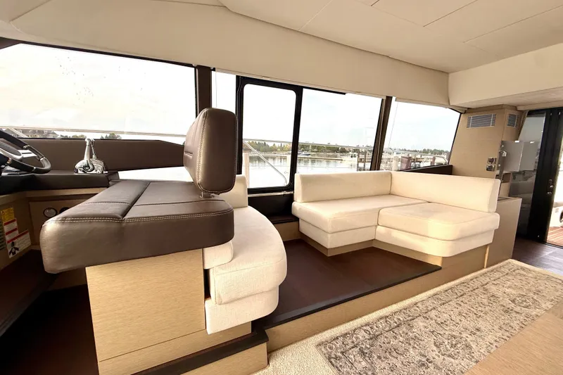 Freiheit Yacht Photos Pics Luxurious interior of 2020 Prestige 590 yacht with plush seating and panoramic windows.