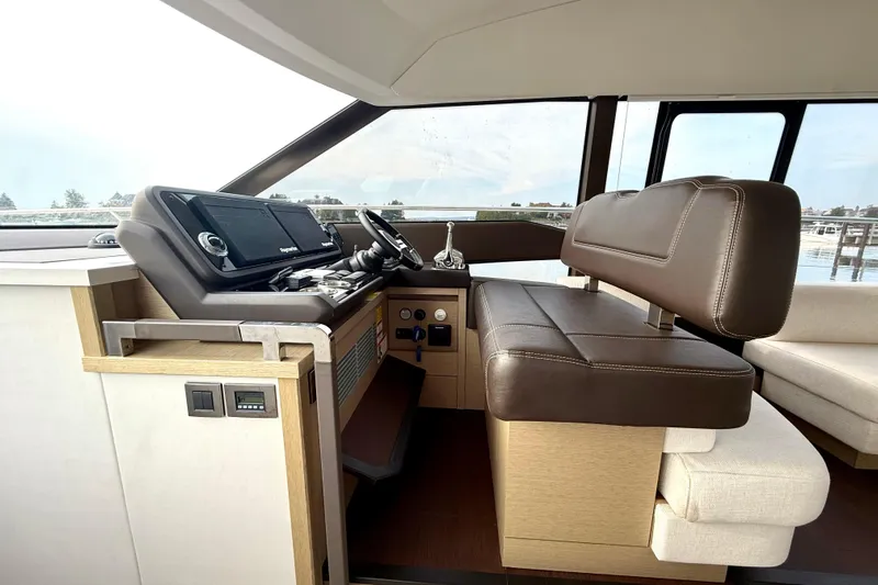 Freiheit Yacht Photos Pics Luxurious interior of 2020 Prestige 590 yacht with modern helm and leather seating.