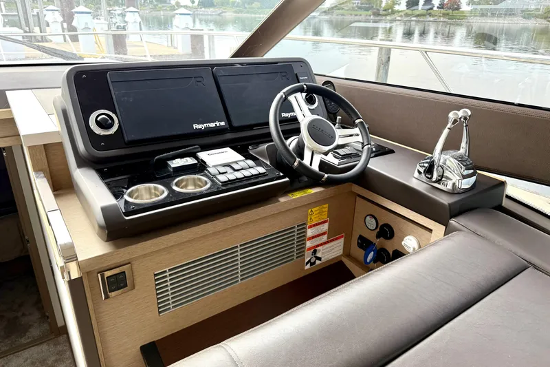 Freiheit Yacht Photos Pics Cockpit of 2020 Prestige 590 yacht with Raymarine navigation system and modern controls.