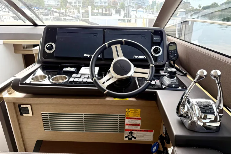 Freiheit Yacht Photos Pics Cockpit of 2020 Prestige 590 yacht with modern navigation controls and steering wheel.