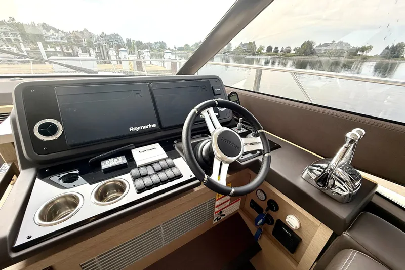 Freiheit Yacht Photos Pics Cockpit of 2020 Prestige 590 yacht with Raymarine navigation system and Cummins controls.