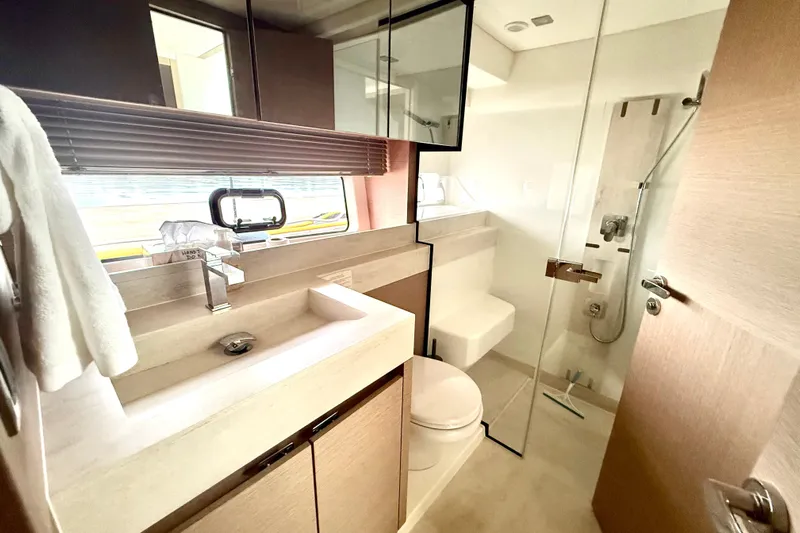 Freiheit Yacht Photos Pics Luxurious bathroom in 2020 Prestige 590 yacht with modern fixtures and glass shower.