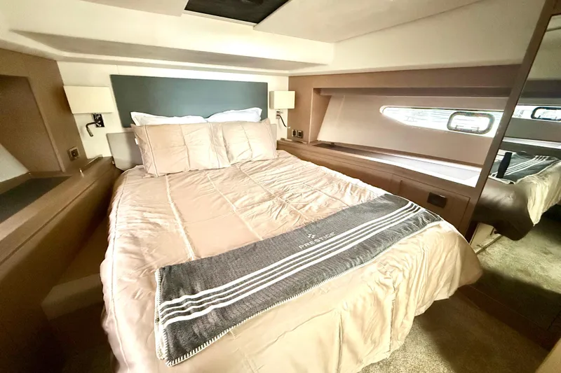 Freiheit Yacht Photos Pics Luxurious bedroom interior of 2020 Prestige 590 yacht with elegant bedding and modern design.