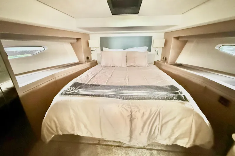 Freiheit Yacht Photos Pics Luxurious bedroom interior of 2020 Prestige 590 yacht with elegant bedding and modern design.