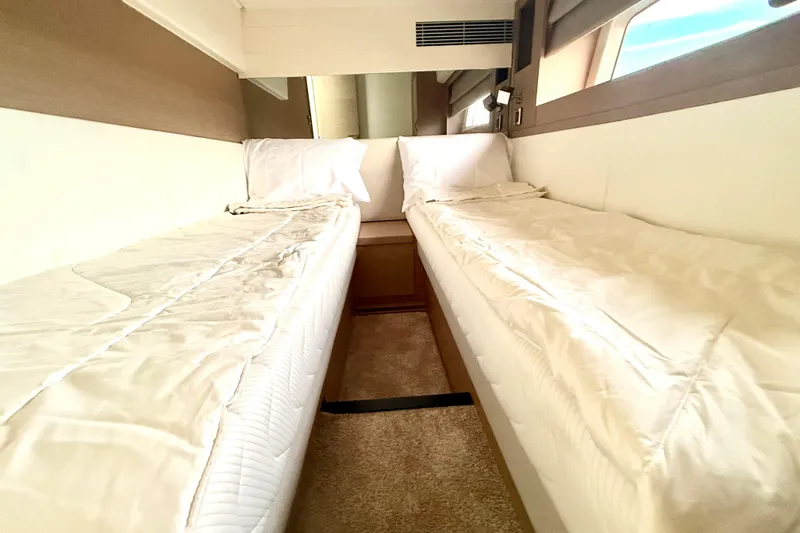 Freiheit Yacht Photos Pics Twin beds in a 2020 Prestige 590 yacht cabin, featuring modern design and comfort.