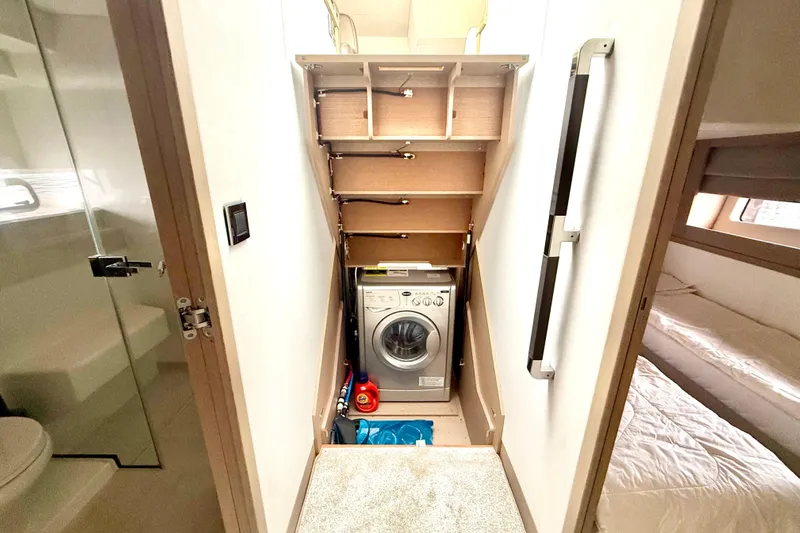 Freiheit Yacht Photos Pics Laundry area in 2020 Prestige 590 yacht with washing machine and storage shelves.