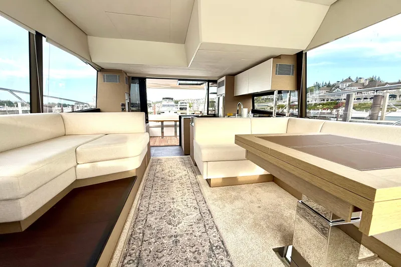 Freiheit Yacht Photos Pics Luxurious interior of a 2020 Prestige 590 yacht with elegant seating and dining area.