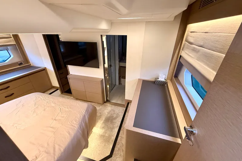 Freiheit Yacht Photos Pics Luxurious interior of 2020 Prestige 590 yacht bedroom with modern furnishings and natural light.