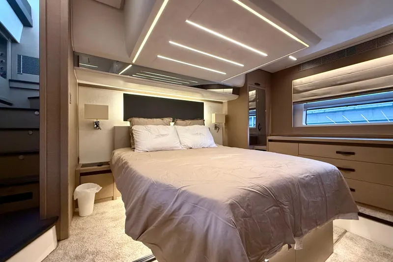 Freiheit Yacht Photos Pics Luxurious bedroom interior of 2020 Prestige 590 yacht with modern lighting and elegant furnishings.