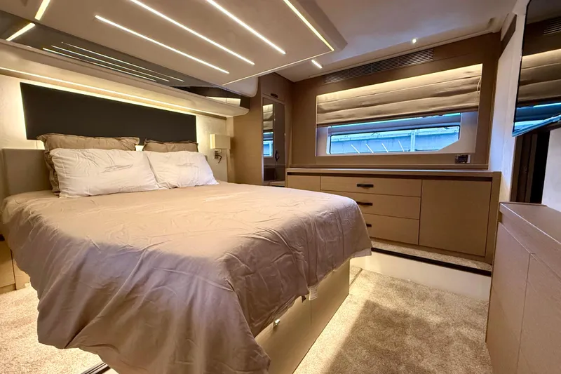 Freiheit Yacht Photos Pics Luxurious bedroom interior of 2020 Prestige 590 yacht with modern lighting and elegant furnishings.