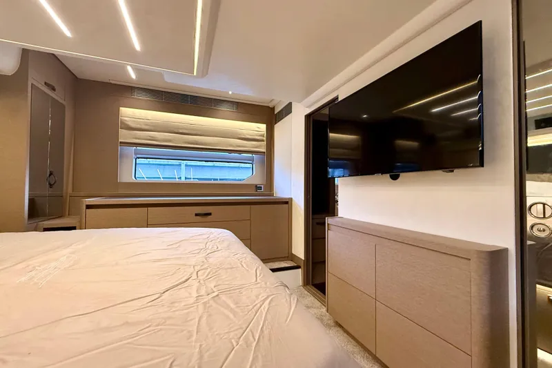 Freiheit Yacht Photos Pics Luxurious interior of 2020 Prestige 590 yacht with modern furnishings and large TV.