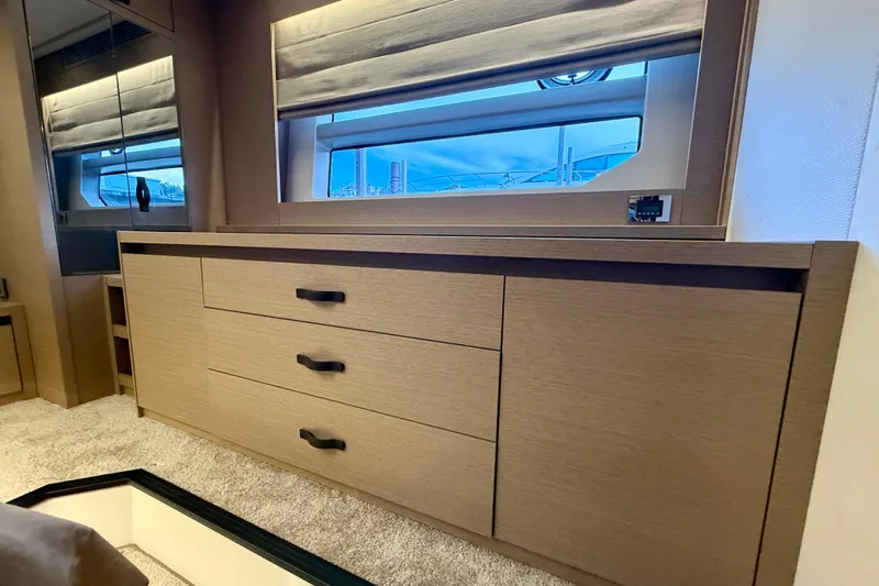 Freiheit Yacht Photos Pics Luxurious interior of 2020 Prestige 590 yacht with sleek wooden cabinetry and modern design.