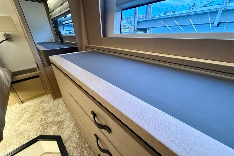 Freiheit Yacht Photos Pics Luxurious interior of 2020 Prestige 590 yacht with sleek cabinetry and large window view.