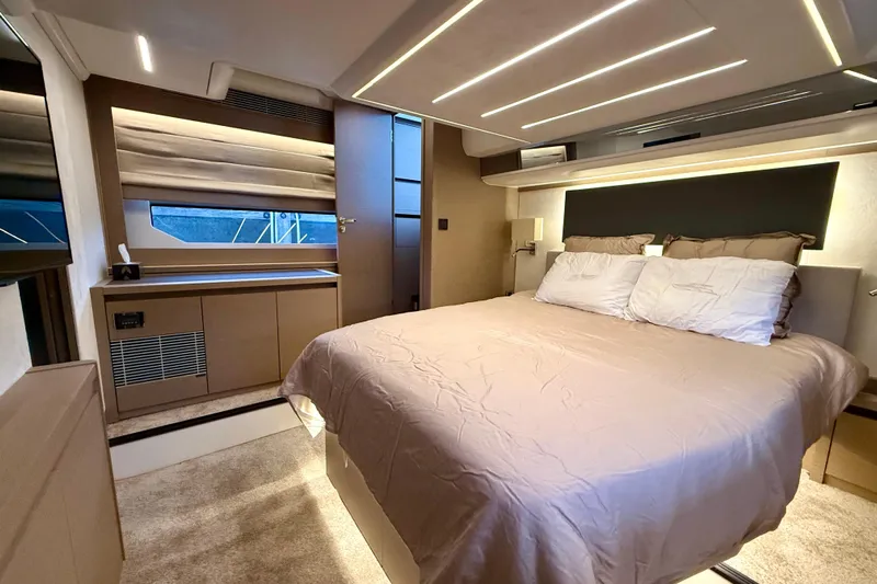 Freiheit Yacht Photos Pics Luxurious bedroom interior of 2020 Prestige 590 yacht with modern design and ambient lighting.