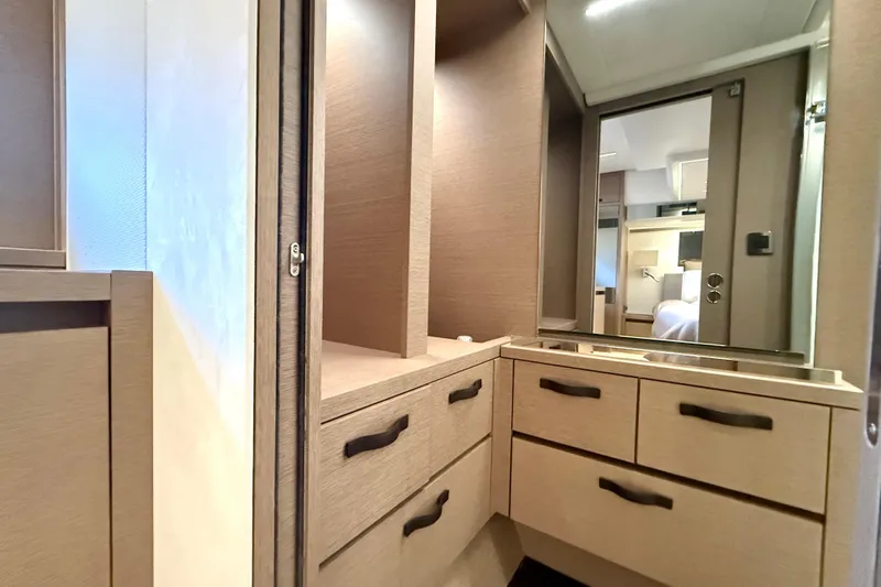 Freiheit Yacht Photos Pics Luxurious interior of 2020 Prestige 590 yacht featuring elegant wood cabinetry and modern design.