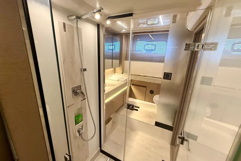 Freiheit Yacht Photos Pics Luxurious bathroom interior of 2020 Prestige 590 yacht with modern shower and sleek design.