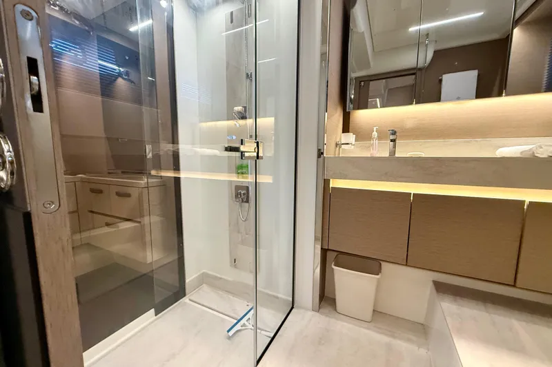 Freiheit Yacht Photos Pics Luxurious bathroom in 2020 Prestige 590 yacht with glass shower and modern vanity.