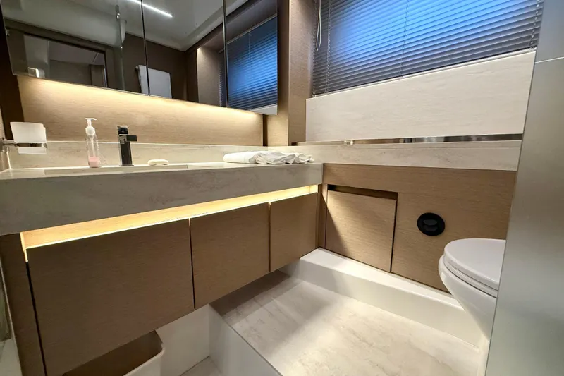 Freiheit Yacht Photos Pics Modern bathroom interior on 2020 Prestige 590 yacht, featuring sleek design and ambient lighting.