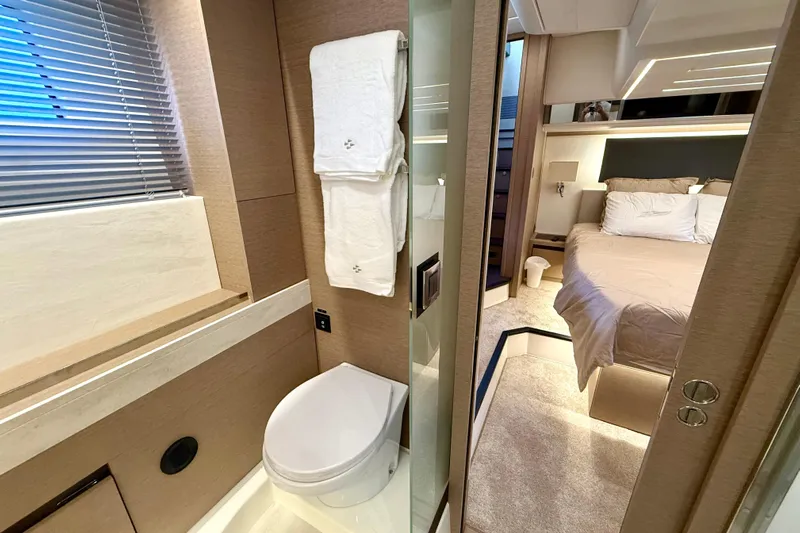 Freiheit Yacht Photos Pics Luxurious 2020 Prestige 590 yacht interior featuring a modern bathroom and cozy bedroom.