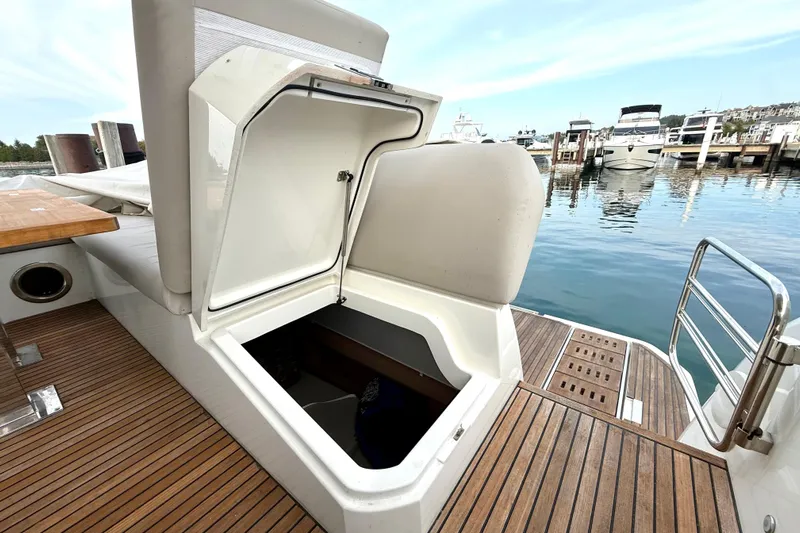 Freiheit Yacht Photos Pics Prestige 590 yacht (2020) with open storage compartment, docked at marina.