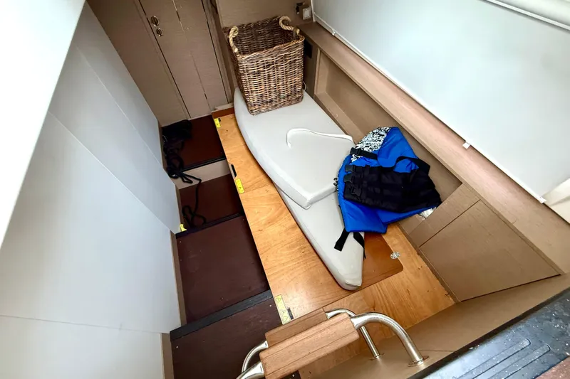 Freiheit Yacht Photos Pics Interior of 2020 Prestige 590 yacht with storage, life jackets, and wicker basket.