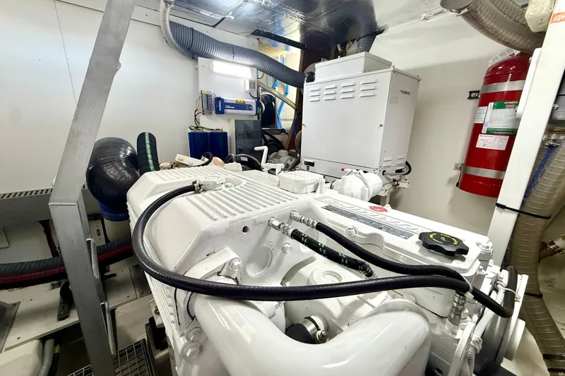 Freiheit Yacht Photos Pics Engine room of a 2020 Prestige 590 yacht, featuring machinery and safety equipment.