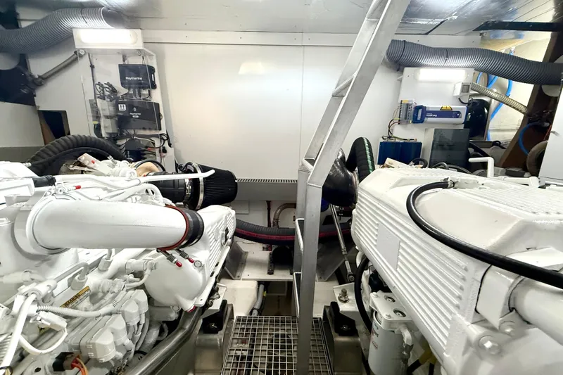 Freiheit Yacht Photos Pics Engine room of a 2020 Prestige 590 yacht, featuring dual engines and modern equipment.