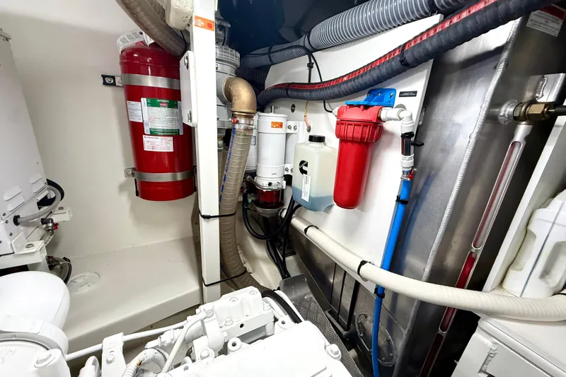 Freiheit Yacht Photos Pics Engine room of a 2020 Prestige 590 yacht with fire extinguisher and filtration system.