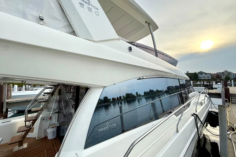 Freiheit Yacht Photos Pics Luxury 2020 Prestige 590 yacht docked at marina during sunset.
