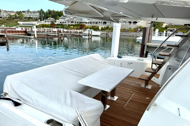 Freiheit Yacht Photos Pics Prestige 590 yacht deck, 2020 model, featuring elegant seating and scenic marina view.