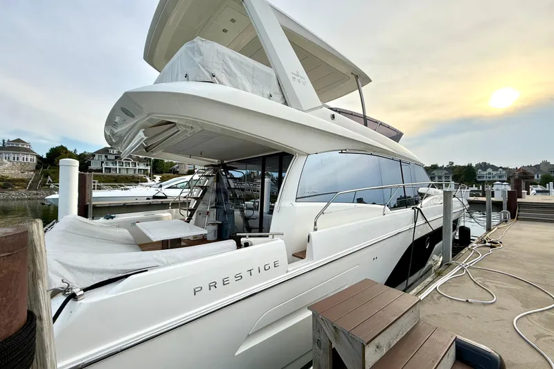 Freiheit Yacht Photos Pics Luxury 2020 Prestige 590 yacht docked at marina during sunset.