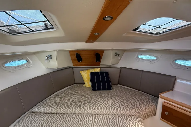 Frisky Yacht Photos Pics 2022 Cutwater C-32 CB cabin interior with skylights, cushions, and modern design.