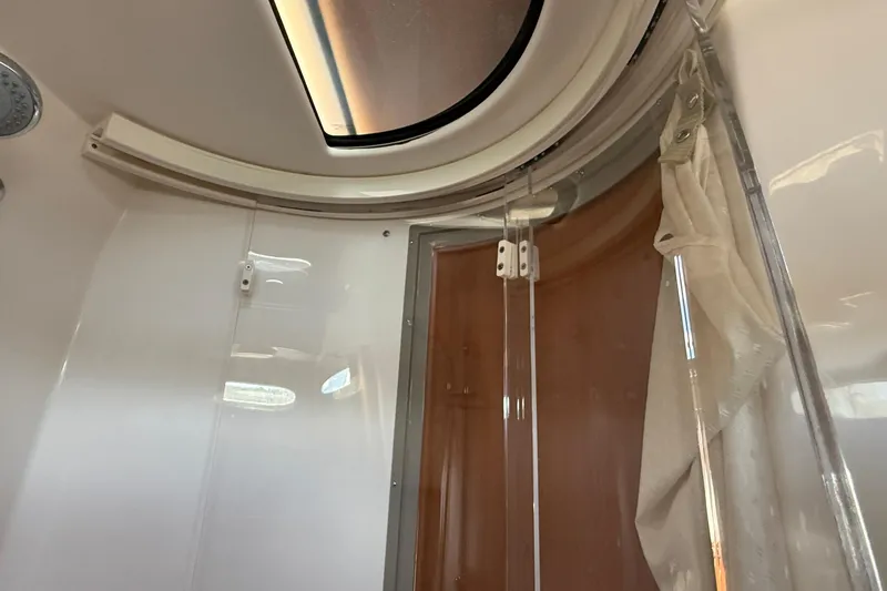 Frisky Yacht Photos Pics Interior view of 2022 Cutwater C-32 CB boat cabin with skylight and curtain.