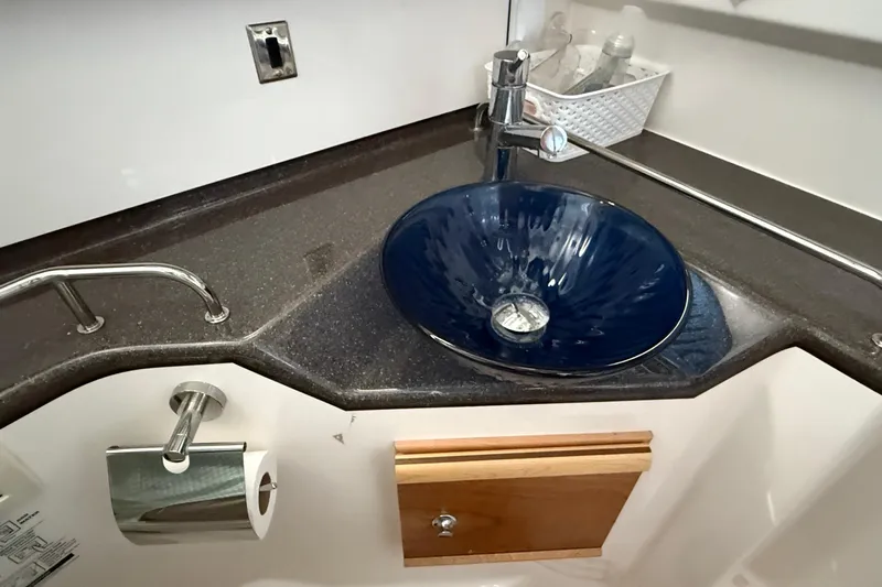 Frisky Yacht Photos Pics 2022 Cutwater C-32 CB bathroom with blue vessel sink and modern fixtures.