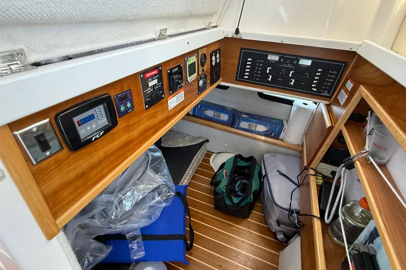 Frisky Yacht Photos Pics 2022 Cutwater C-32 CB cabin interior with control panels and storage compartments.