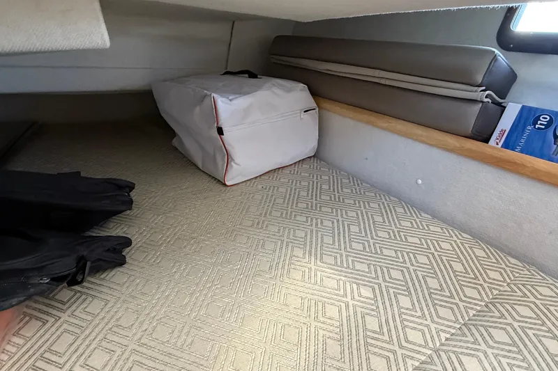 Frisky Yacht Photos Pics Interior cabin storage area of 2022 Cutwater C-32 CB boat with patterned flooring.