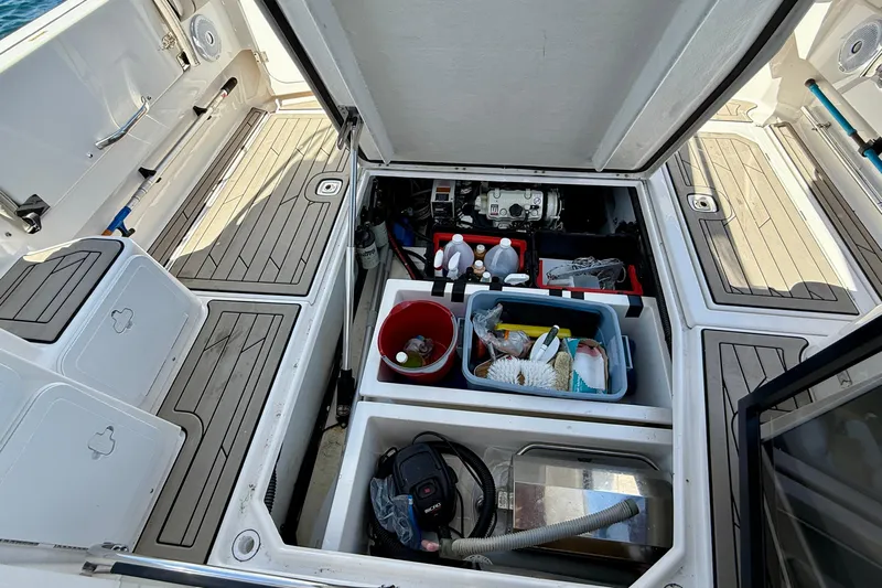 Frisky Yacht Photos Pics 2022 Cutwater C-32 CB boat storage compartments with cleaning supplies and equipment.