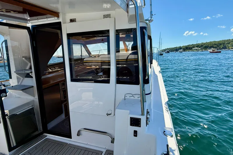 Frisky Yacht Photos Pics 2022 Cutwater C-32 CB boat interior with open door, overlooking scenic water and sky.