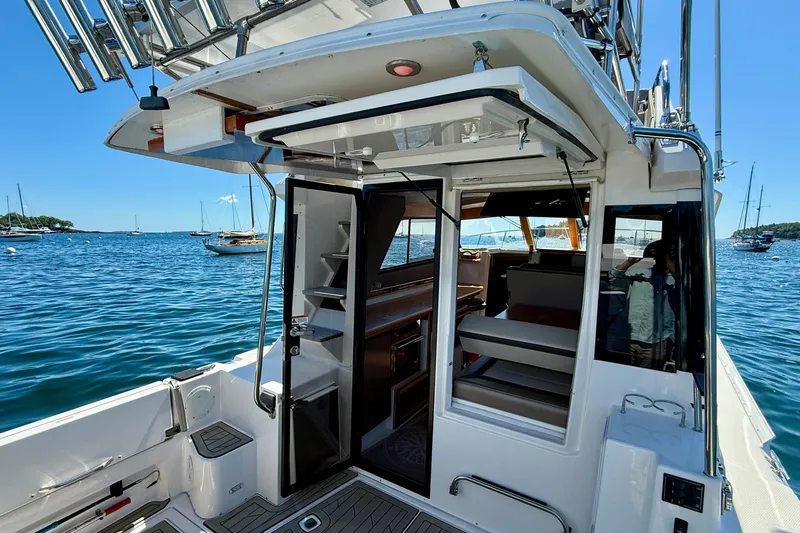 Frisky Yacht Photos Pics 2022 Cutwater C-32 CB boat interior with open doors, docked on a sunny day.