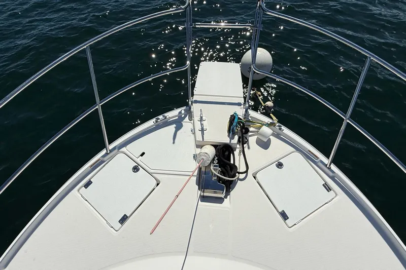 Frisky Yacht Photos Pics Bow view of 2022 Cutwater C-32 CB boat with railing and anchor equipment.