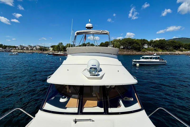 Frisky Yacht Photos Pics 2022 Cutwater C-32 CB yacht on scenic blue water with clear sky.