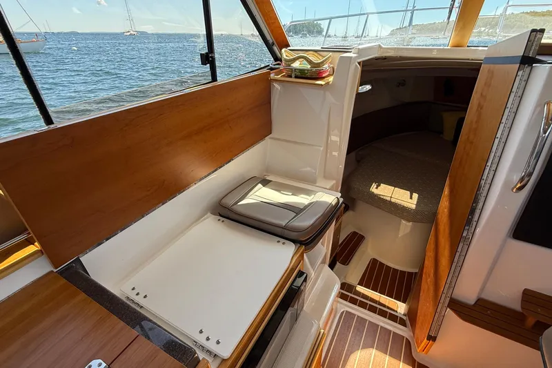 Frisky Yacht Photos Pics 2022 Cutwater C-32 CB interior with wood accents, seating, and cabin view.