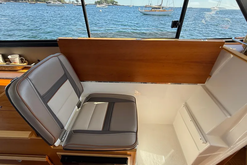 Frisky Yacht Photos Pics 2022 Cutwater C-32 CB interior with cushioned seating and ocean view.