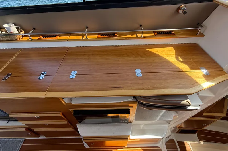 Frisky Yacht Photos Pics 2022 Cutwater C-32 CB interior with wooden cabinetry and sleek design elements.