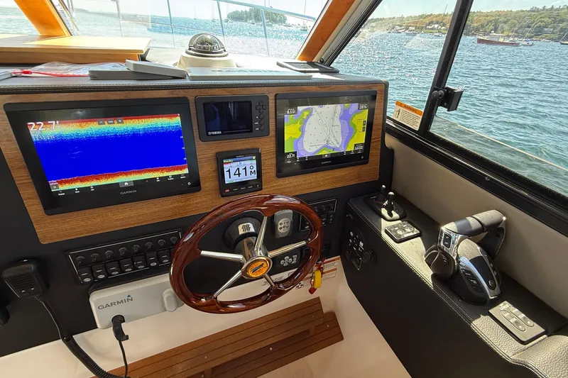 Frisky Yacht Photos Pics Interior helm of 2022 Cutwater C-32 CB boat with navigation screens and controls.